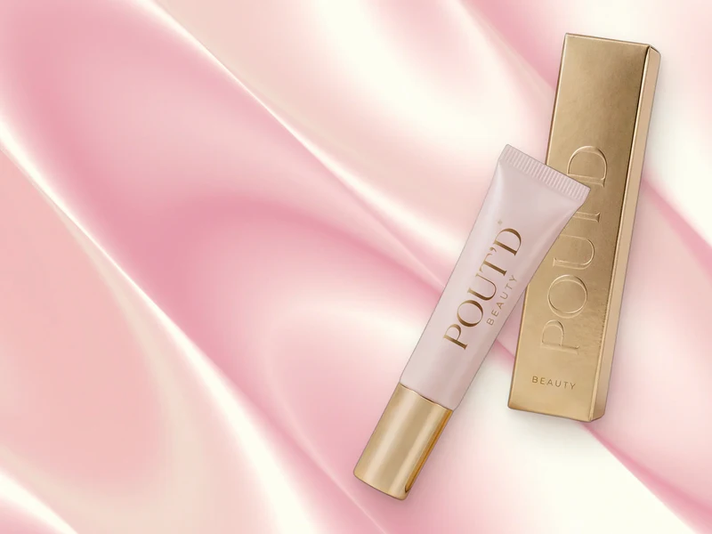 POUT'D Lip Plumper on pink silk: the glossy $25 tube behind a fuller-looking pout without filler.