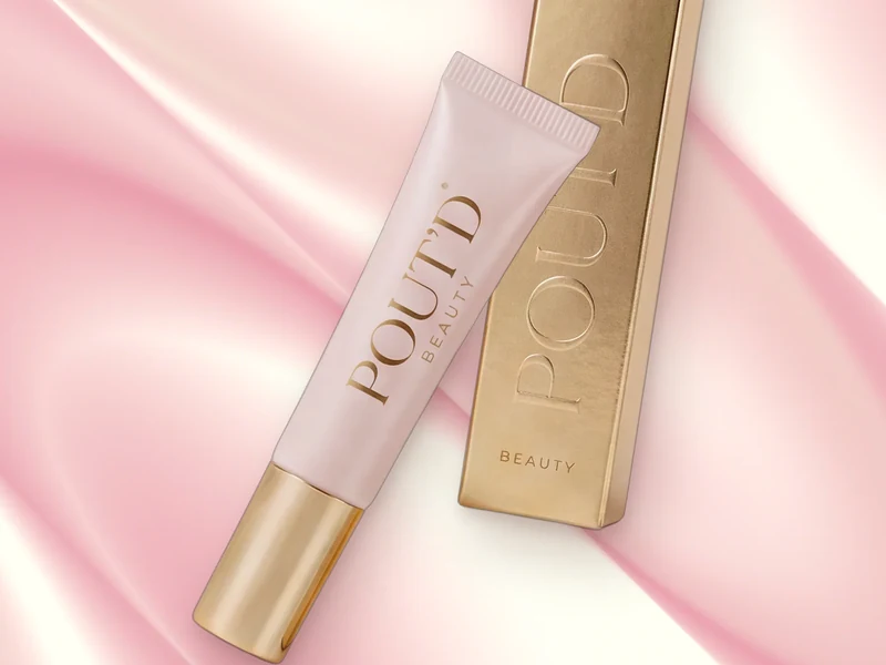 POUT'D lip plumper tube and gold box on pink silk, a high-shine gloss for soft, hydrated-looking lips, $25.